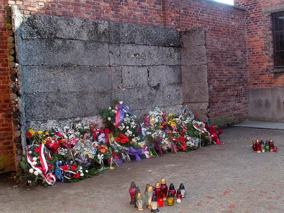 Kwiaty przed Ścianą Straceń w b. Auschwitz w Narodowe Święto Niepodległości